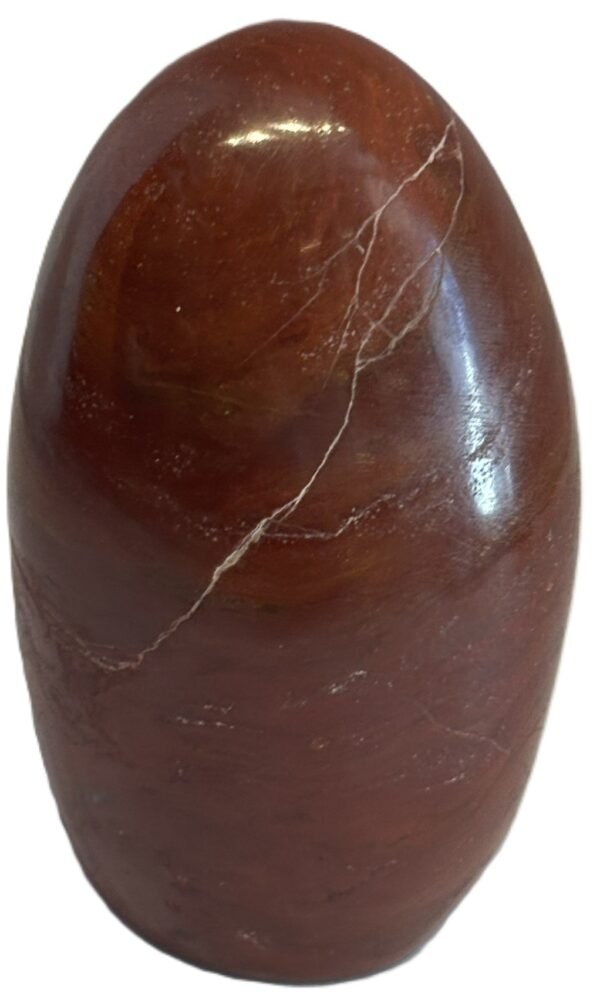 Polished carnelian standing freeform specimen5 4 sians emporium Polished reddish brown oval gemstone with a pale white vein running diagonally across its surface